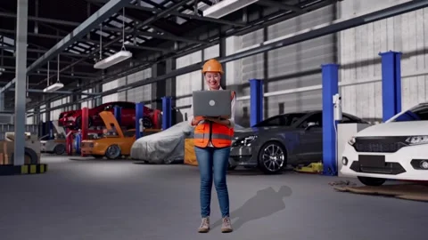 Female Engineer Working On A Laptop in Auto Repair Shop Stock Footage 313530182
