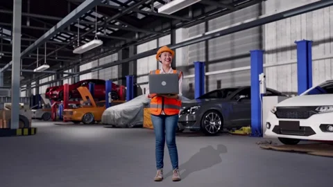 Female Engineer Working On A Laptop in Auto Repair Shop Stock Footage 313530209