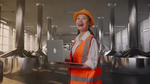 Female Engineer Working On A Laptop at Beer Plant Stock Footage 332546501