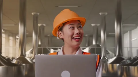 Female Engineer Working On A Laptop at Beer Plant Stock Footage 332547162