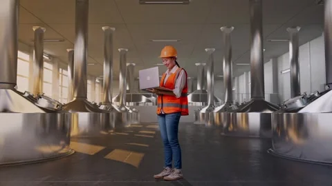 Female Engineer Working On A Laptop at Beer Plant Stock Footage 332547866