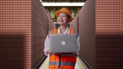Female Engineer Working On A Laptop With Brick In Stacks Stock Footage 303761869