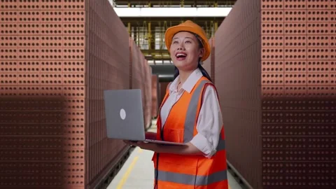 Female Engineer Working On A Laptop With Brick In Stacks Stock Footage 303762096