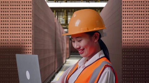 Female Engineer Working On A Laptop With Brick In Stacks Stock Footage 303762665
