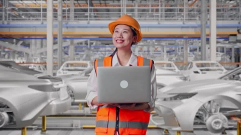 Female Engineer Working On A Laptop In Car Factory Stock Footage 331632040