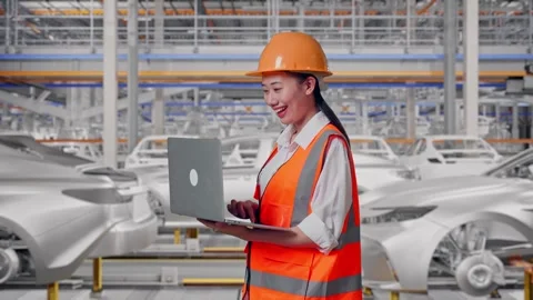 Female Engineer Working On A Laptop In Car Factory Stock Footage 331632109