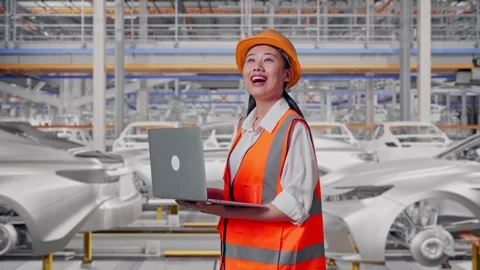 Female Engineer Working On A Laptop In Car Factory Stock Footage 331632113