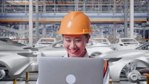Female Engineer Working On A Laptop In Car Factory Stock Footage 331632545