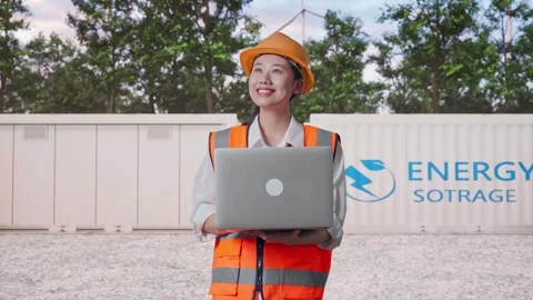 Female Engineer Working On A Laptop with Energy Storage Stock Footage 337818971