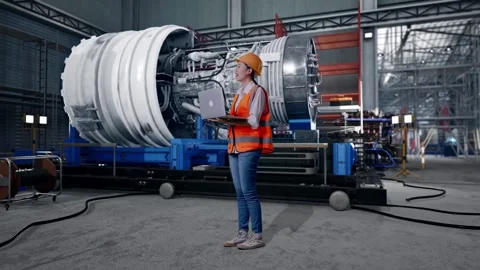 Female Engineer Working On A Laptop With Jet Engine Stock Footage 306607637