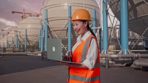 Female Engineer Working On A Laptop with Spherical Tank Stock Footage 335068609