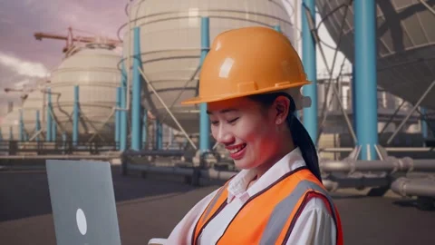 Female Engineer Working On A Laptop with Spherical Tank Stock Footage 335069191