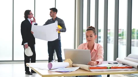 Female engineer working with paperwork and equipment on the table with engineer. Stock-Footage 142877256