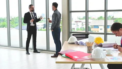 Female engineer working with paperwork and equipment on the table with engineer. Stock-Footage 142915699