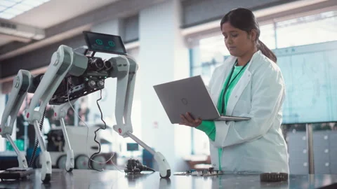 Female Engineer Working on a Robot Stock Footage 243250904