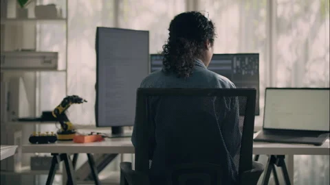 Female engineer working with robotics and multiple computer screens. Stock Footage 319001311