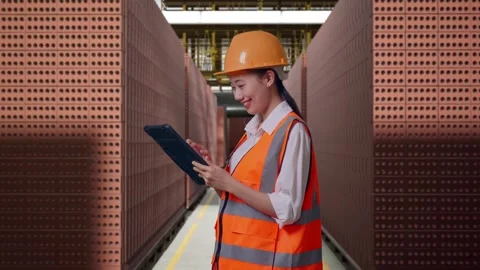 Female Engineer Working On A Tablet With Brick In Stacks Stock Footage 303762001