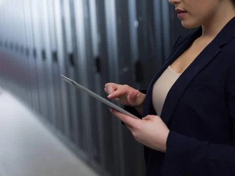 Female engineer working on a tablet computer in server room Female IT engi... Stock-Fotos