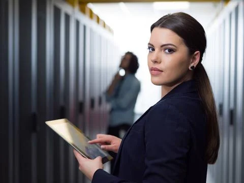 Female engineer working on a tablet computer in server room Female IT engi... Stock-Fotos