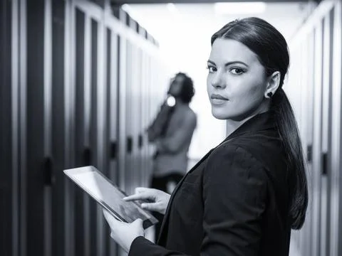 Female engineer working on a tablet computer in server room Female IT engi... Stock-Fotos