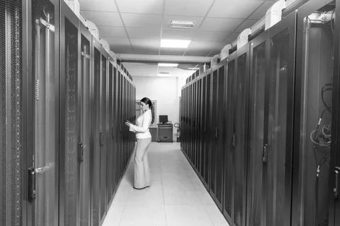 Female engineer working on a tablet computer in server room Female IT engi... Stock-Fotos