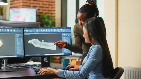 Female engineers analyzing clamp component prototype Stock Photos