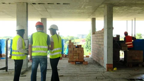 Female engineers and builder discuss talk at construction site Stock Footage 317610669