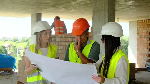 Female engineers and builder study building layout Video stock 317610837
