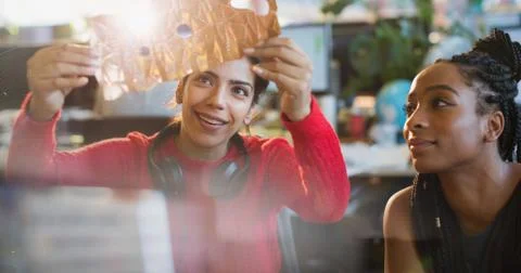 Female engineers examining prototype in office Stock Photos