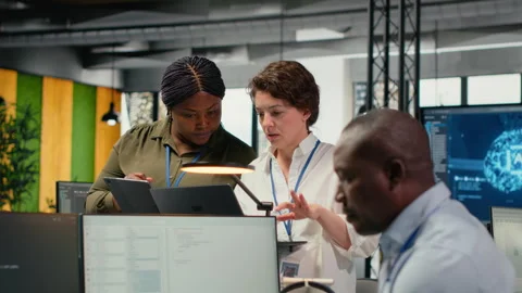 Female engineers in startup office using AI technology driving market innovation Video stock 322697122