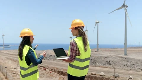 Female engineers work at Alternative Renewable wind Energy Farm - Clean and sust Stock Footage 246538727