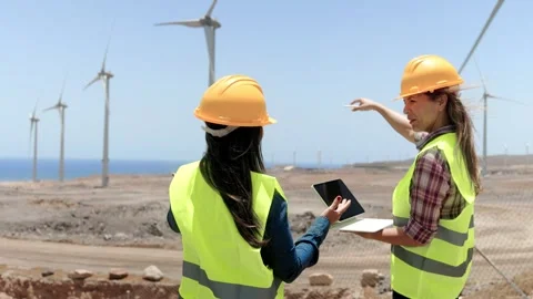 Female engineers work at Alternative Renewable wind Energy Farm - Clean and sust Stock Footage 249746440