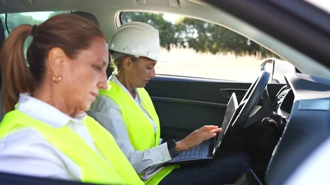Female engineers working with laptop inside a car Stock Footage 344564211