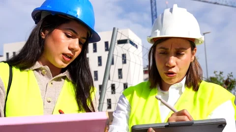 Female engineers working together on a construction site Stock Footage 334578232