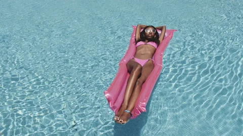 Female Enjoying Alone Time by the Floatie on the Pool During Summer Video stock 138178397