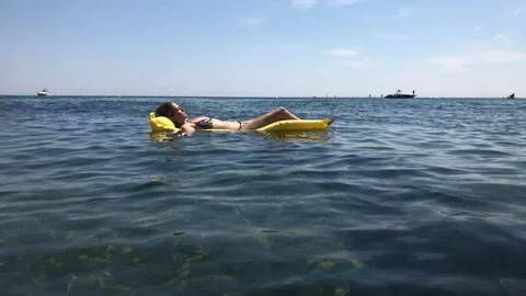 Female enjoys sun on beautiful French coast Stock Footage