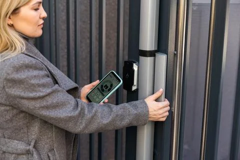 Female entering secret key code for getting access and passing building using Stock Photos