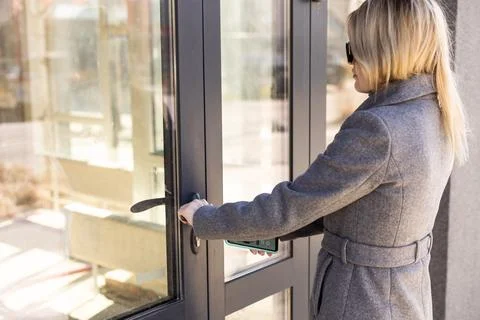 Female entering secret key code for getting access and passing building using 写真素材
