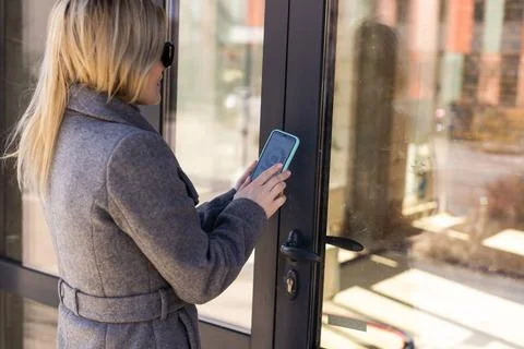 Female entering secret key code for getting access and passing building using 스톡 사진