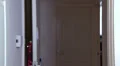 Female enters house on mobile phone HD Footage
