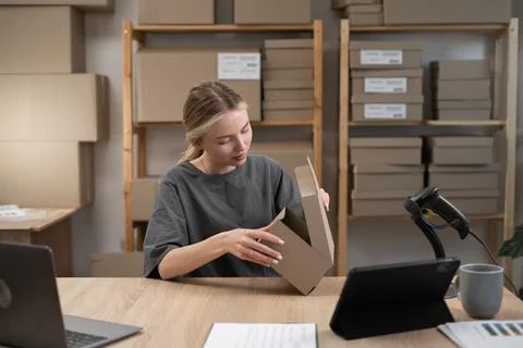 Female Entrepreneur owner packing boxes to customers working in online sme bu Stock Photos