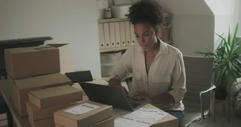 Female Entrepreneur Preparing Parcel Boxes for Shipment at Home Stock Footage 166808087
