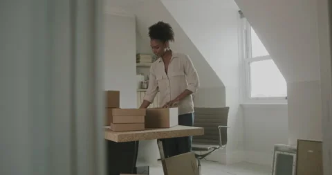 Female Entrepreneur Preparing Parcel Boxes for Shipment at Home Stock Footage 166808962