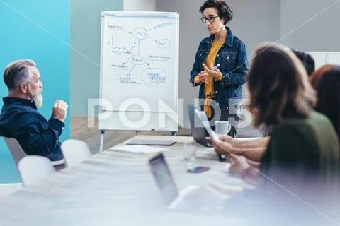 Female entrepreneur sharing business plans Stock Photos