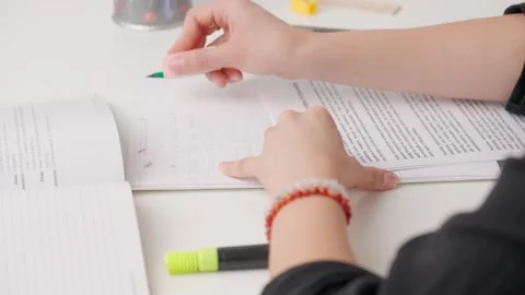 Female erasing wrong answer in standard exam test paper book with eraser Stock Footage 280168055