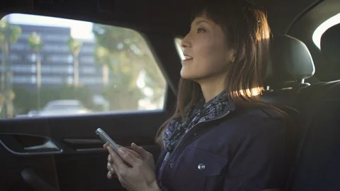 Female executive looking through window while travelling in a cab Stock Footage 105616227