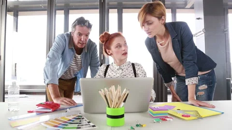 Female executive presenting new project on laptop to director and colleague Stock Footage 59543845
