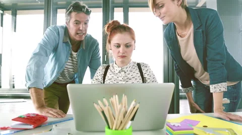 Female executive presenting new project on laptop to director and colleague Stock Footage 59543866