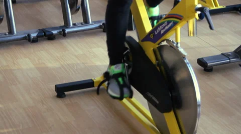Female exercising their legs doing cardio cycling training Stock Footage 36689149