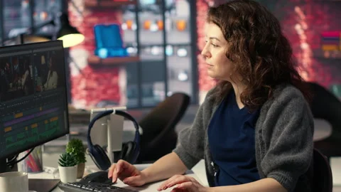 Female expert editor working in video production industry at agency office Stock Footage 308597764